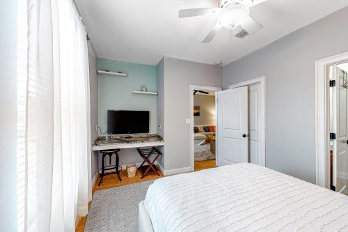 a bedroom with a bed and a flat screen tv at Topsail Village Away on Wildflower in Santa Rosa Beach
