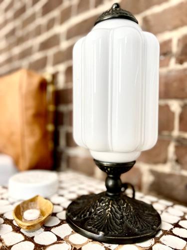 a black and white candle on a table at Be Our Gaston's "The Garden of Good" in Savannah