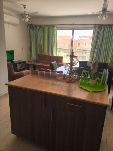 a kitchen with a large island in a living room at Chalet duplex in El Alamein