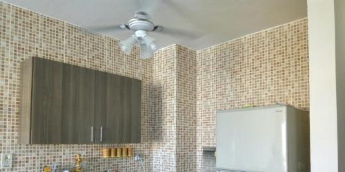 a bathroom with a mirror and a ceiling fan at Chalet duplex in El Alamein