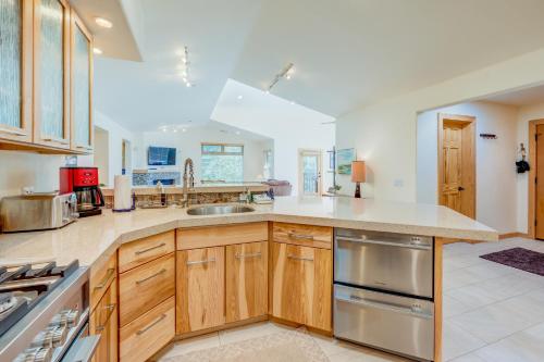 a large kitchen with wooden cabinets and stainless steel appliances at Totally Tahoe Townhome in Crystal Bay