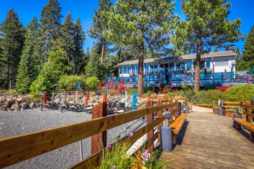 a resort with wooden benches and a building at Totally Tahoe Townhome in Crystal Bay