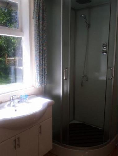 a bathroom with a shower and a sink and a sink at Tirbi Holiday House in Kassari