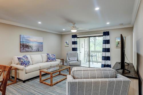 a living room with a couch and a table at Bend in the Road 2003 in Seabrook Island