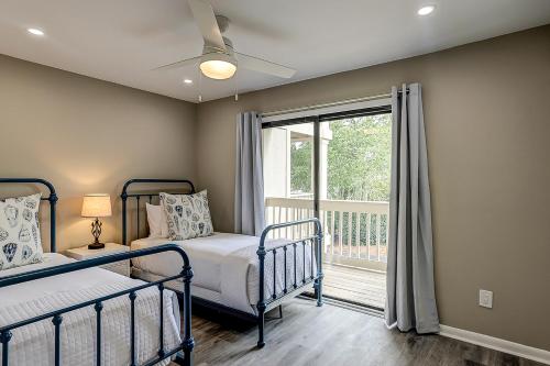 a bedroom with two bunk beds and a window at Bend in the Road 2003 in Seabrook Island