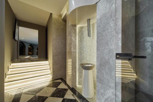 a bathroom with a shower with a toilet in it at La Fleur Boutique Hotel in Tivat