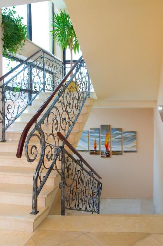 a staircase with a wrought iron railing at Hotel Rigga in Władysławowo