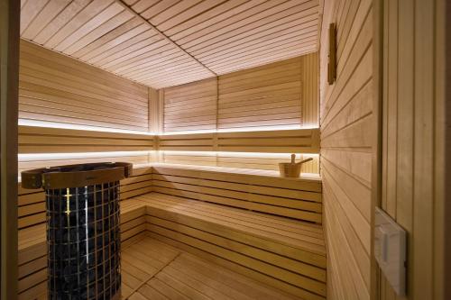a wooden sauna with a wooden floor and a window at La Fleur Boutique Hotel in Tivat