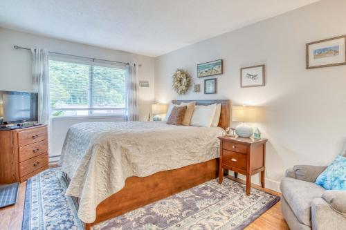 a bedroom with a bed and a window and a couch at The Bullpen 129 in Neskowin