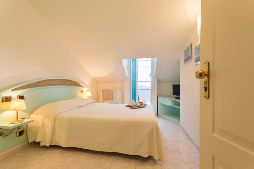 a bedroom with a white bed and a window at Hotel 4 Venti spa & wellness in Sestri Levante