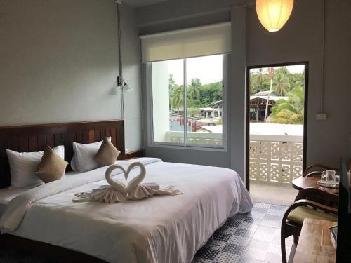 a bedroom with a bed with a heart decoration on it at Thaimueang Boutique Hotel in Thai Muang