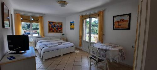 a bedroom with a bed and a tv in it at Villa Playa del Sol - B2 in Saint-Tropez
