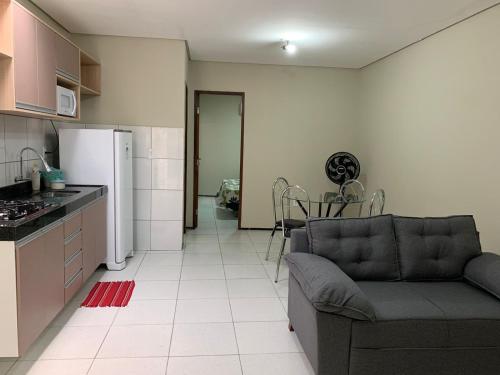 a kitchen and living room with a couch and a refrigerator at Residencial Milagre 202 in Juazeiro do Norte