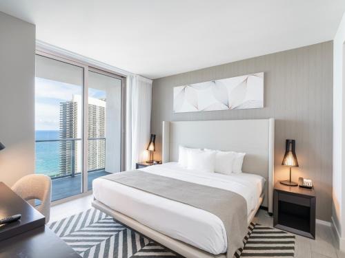 a bedroom with a large bed and a large window at Modern Waterfront Retreat with Scenic Views in Hollywood