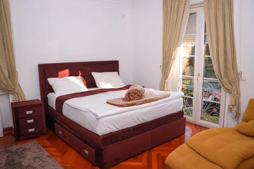 a bedroom with a bed with a towel on it at Villa Dedinje in Belgrade