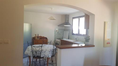 een keuken met een tafel en een keuken met een wastafel bij Bas de Villa chez Mr.Girolami Dominique in Bastia