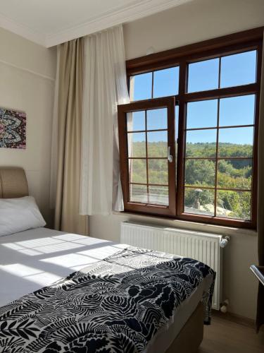 Ένα ή περισσότερα κρεβάτια σε δωμάτιο στο Kerpe Diem Otel