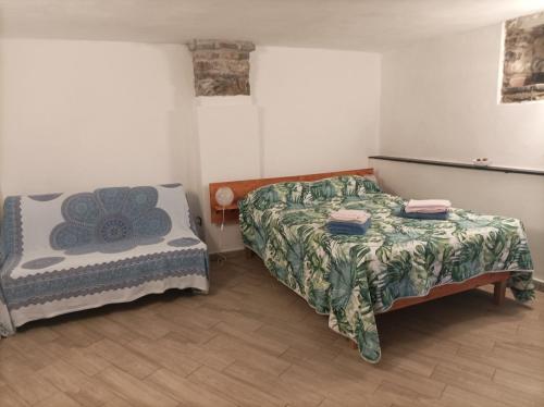 a bedroom with two beds and a table and a bed at lotus flower in Sant'Olcese