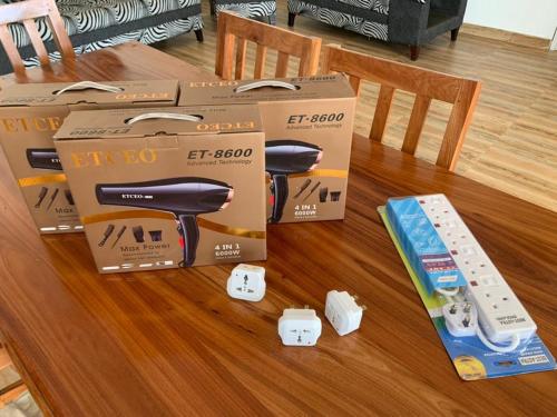 a group of boxes on a table with a video game controller at Villa Liam B&B Kiwengwa Zanzibar in Kumba Urembo