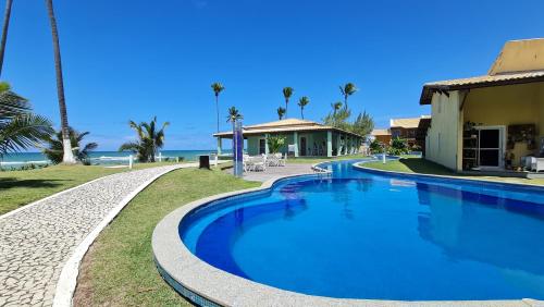 La alberca dentro o cerca de Paraíso PÉ NA AREIA no coração do Litoral Norte - FRENTE MAR - Loft projetado para que você tenha a melhor experiência em hospedagem - condomínio mais procurado da Estrada do Côco - Varanda com vista espetacular para o mar - lazer e TRANQUILIDADE