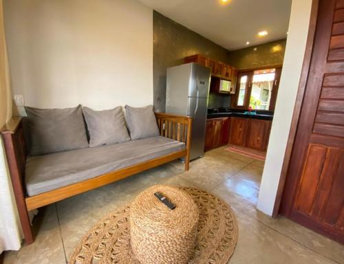 a living room with a couch and a kitchen at La Casina Jericoacoara in Jericoacoara