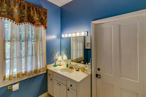 a bathroom with a sink and a mirror at Steele Cottage in Vicksburg