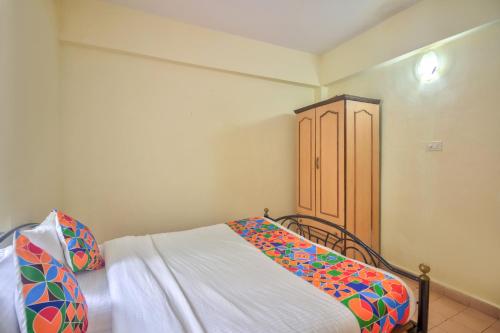 a bedroom with a bed and a wooden cabinet at Hilltop 4 BHK Villa with Private Swimming Pool near Candolim in Old Goa