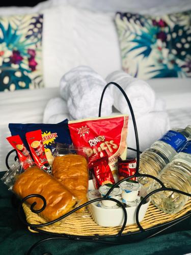 a basket filled with bread and other food on a table at MeeZee Pearl Double Bed Lodge With Free Parking in Manchester