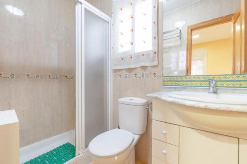 a bathroom with a toilet and a sink and a shower at Casita entre naranjas in Formentera de Segura