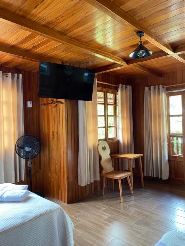 a bedroom with a bed and a television on the ceiling at HAUS KÖHEL HOSPEDAJE POZUZO in Pozuzo