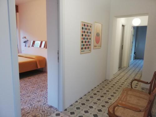 a hallway with a room with a bed and a chair at B&B San Gregorio SINNAI in San Gregorio