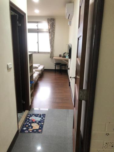 a hallway with a living room and a door to a room at Home run Homestay in Dongyin