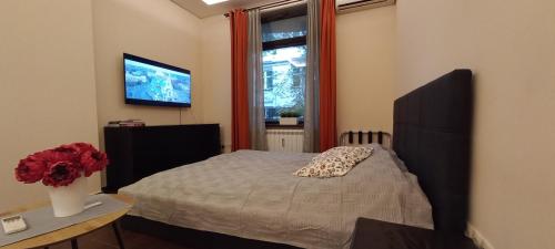 a bedroom with a bed and a window at Embassy Apartment in Sofia