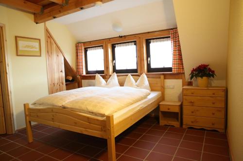 a bedroom with a bed in a room with windows at Ober der Eller in Brotterode