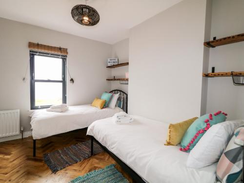 a room with two beds and a couch at Lough Mill House in Newtownabbey