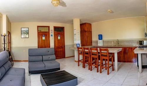 a living room with a couch and a table at Cucuve Eco Hostal in Puerto Baquerizo Moreno