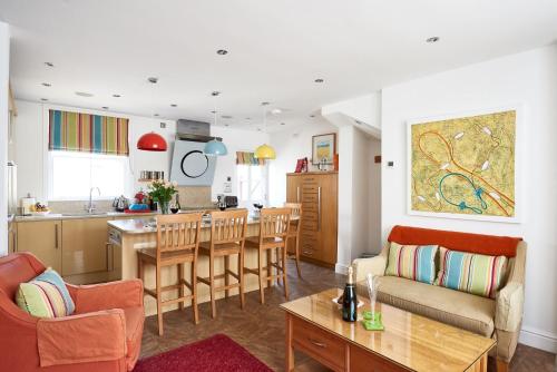 a living room and kitchen with a table and chairs at 252 Aldeburgh Townhouse - Aldeburgh Coastal Cottages in Aldeburgh