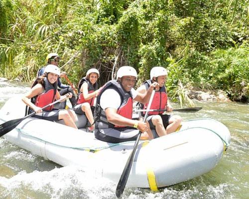 a group of people in a raft on a river at Peace By The River in Jarabacoa