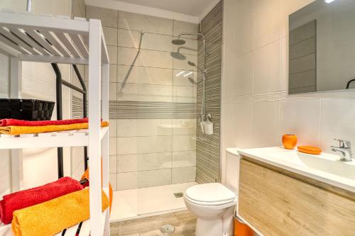 a bathroom with a shower and a toilet and a sink at Orlando - Ocean View Apartment in Costa Adeje in Adeje