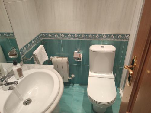 y baño con aseo blanco y lavamanos. en Fuenteazul, en Hortigüela