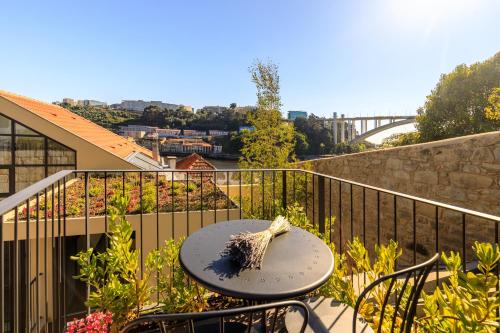 a table and chairs on a balcony with a view at 108MM House in Porto