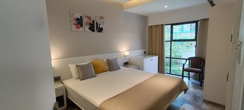 a bedroom with a large bed and a window at Providence, Port Blair in Port Blair