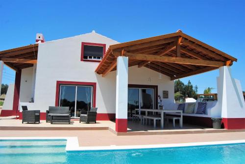 a villa with a swimming pool and a house at Monte D'Vagar by Estilo Lusitano, com piscina privada in Grândola