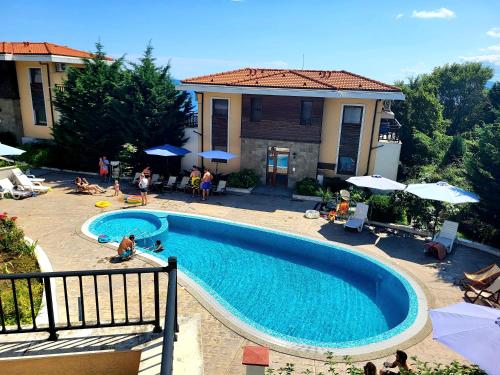 a swimming pool in front of a house at VIP Apartments in Sozopol in Sozopol