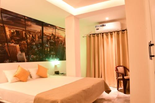 a bedroom with a bed and a painting on the wall at Providence, Port Blair in Port Blair