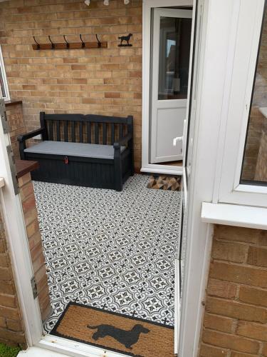 an open door with a bench in front of a door at Vale View Scalford in Scalford