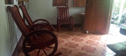 a room with two rocking chairs and a table at Rocks Beach in Balgue