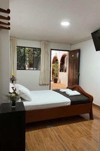 a bedroom with a large bed and a window at Hotel Principe I in Puerto Maldonado