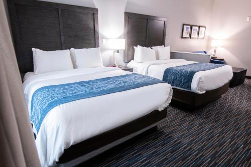 a hotel room with two beds and two lamps at Comfort Inn & Suites Near Medical Center in San Antonio