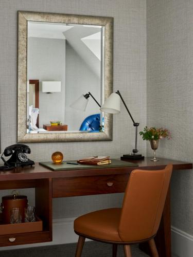 a desk with a mirror and a lamp and a chair at Marine Troon in Troon